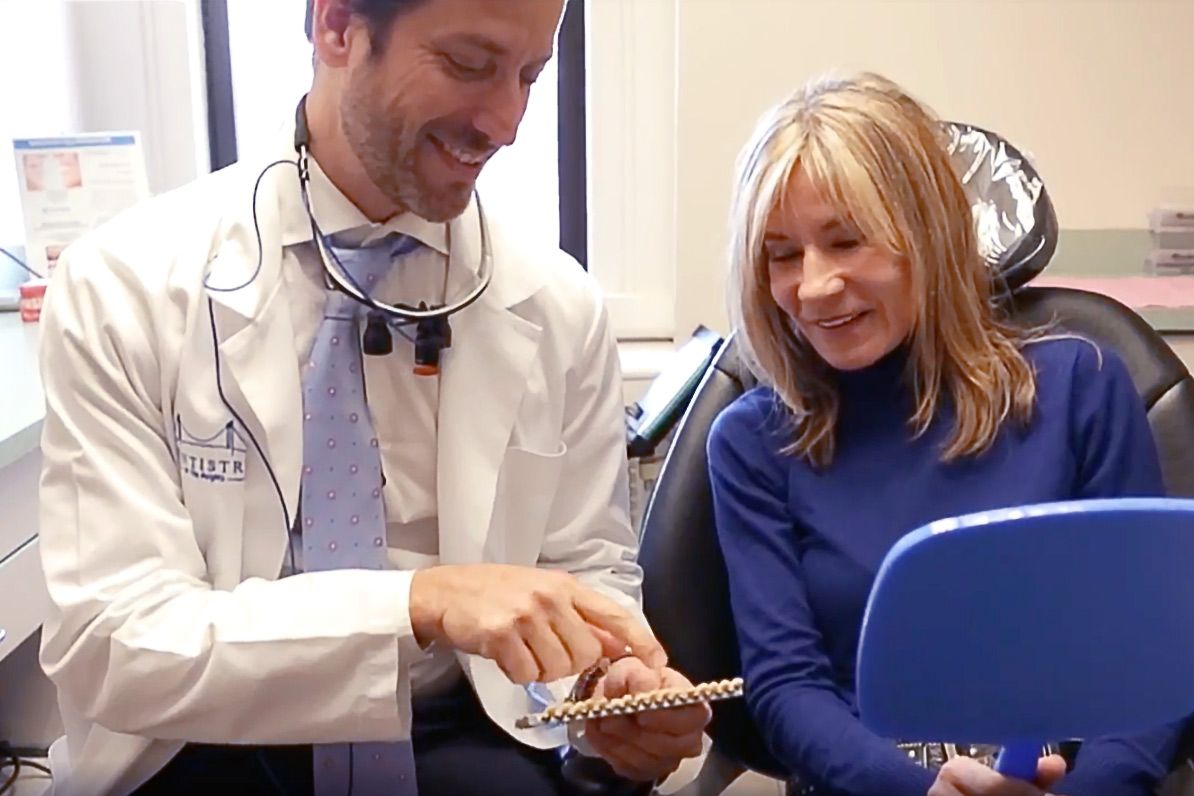 Doctor showing pontics to patient